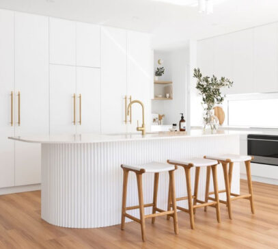 Stunning white and gold luxury kitchen in Perth featuring fluted cabinetry on the island bench