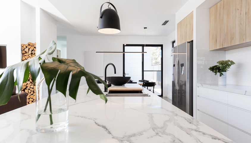 A white marble kitchen countertop inside of a luxury kitchen in Perth that has undergone a custom kitchen renovation.