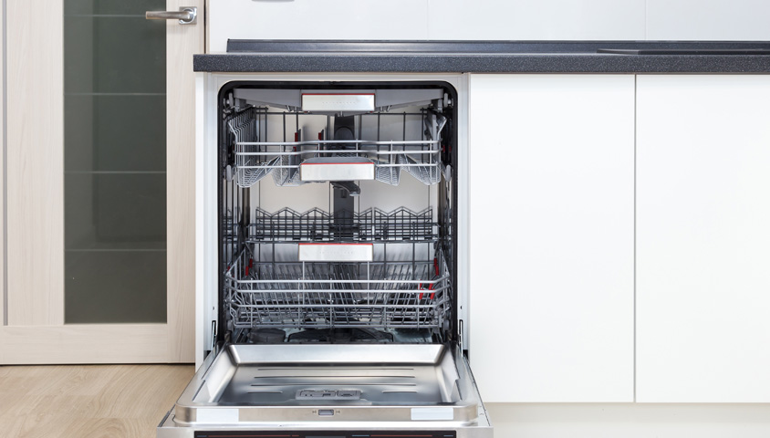 Modern white custom kitchen cabinets with a built-in dishwasher for functionality and aesthetics.